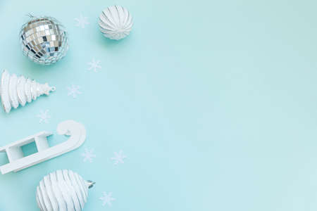 Simply minimal composition winter objects ornament sled fir tree ball isolated on blue pastel trendy...