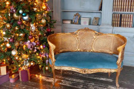 Classic Christmas New Year decorated interior room home library with fireplace. Christmas tree with...