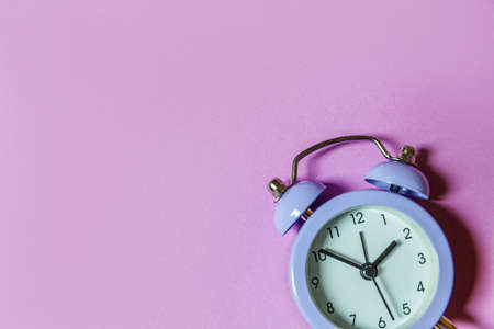 Simply minimal design ringing twin bell vintage classic alarm clock Isolated on purple violet...