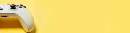 White joystick gamepad, game console isolated on yellow colourful trendy background. Computer gaming...