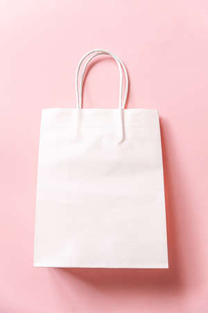Simply minimal design shopping bag isolated on pink pastel background. Online or mall shopping...