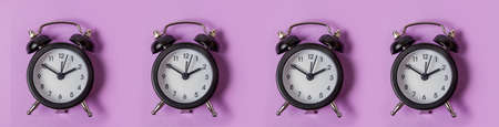 Simply minimal design ringing twin bell vintage classic alarm clock Isolated on purple background....