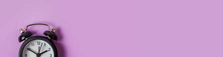 Simply minimal design ringing twin bell vintage classic alarm clock Isolated on purple background....
