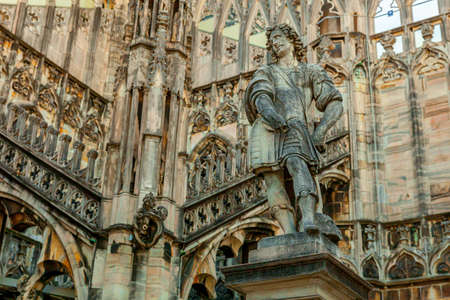 Roof of Milan Cathedral Duomo di Milano with Gothic spires and white marble statues. Top tourist attraction on piazza in Milan, Lombardia, Italy. Wide angle view of old Gothic architecture and artの写真素材