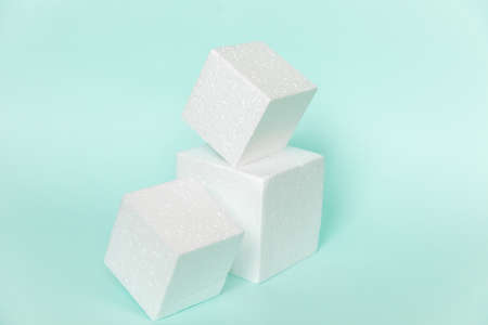 White rectangular cube shapes on blue background. Minimal boxes geometric forms podium. Empty...