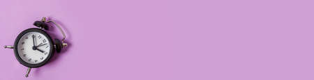 Simply minimal design ringing twin bell vintage classic alarm clock Isolated on purple background....