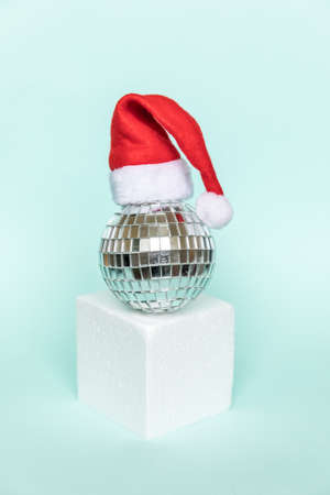 Simply minimal composition disco ball in Santa hat and cube shapes geometric form podium isolated...
