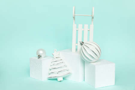 Simply minimal composition winter objects ornament and cube shapes geometric form podium isolated blue pastel background. Christmas New Year december time for celebration concept. Mockup copy spaceの写真素材
