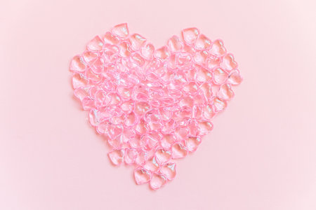 St. Valentine's Day concept. Heart shaped objects many pink hearts isolated on pink pastel background. Postcard banner on valentines day. Love date lovesick wedding romance symbol. Top view flat layの写真素材