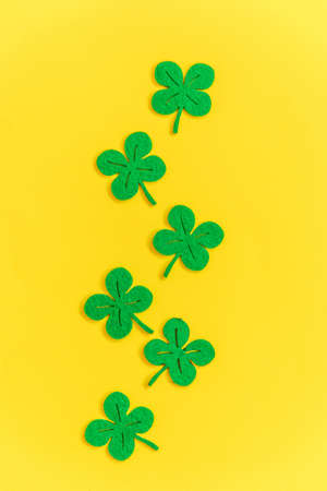 St Patricks Day background. Simply minimal design with green shamrock. Clover leaves isolated on...