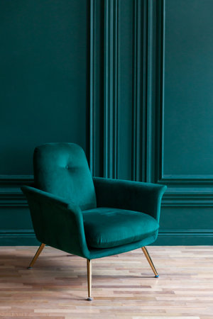 Beautiful luxury classic blue green clean interior room in classic style with green soft armchair. Vintage antique blue-green chair standing beside emerald wall. Minimalist home design