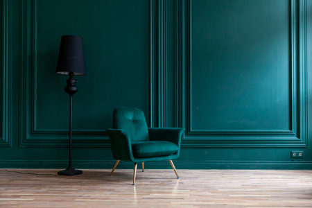 Beautiful luxury classic blue green clean interior room in classic style with green soft armchair. Vintage antique blue-green chair standing beside emerald wall. Minimalist home designの写真素材