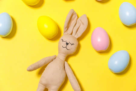 Happy Easter concept. Preparation for holiday. Colorful decorated easter eggs and bunny toy isolated...