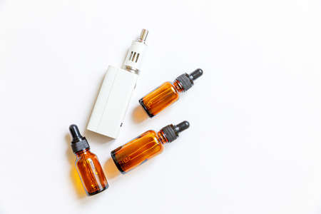 Vaping device e-cigarette electronic cigarette and liquid bottles isolated on white background. Vape...