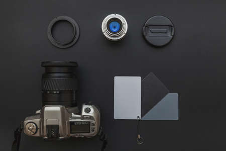 Photographer workplace with dslr camera system, camera cleaning kit, lens and camera accessory on dark black table background. Hobby travel photography concept Flat lay top view copy spaceの写真素材