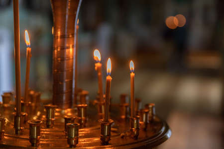 Orthodox Church. Christianity. Festive interior decoration with burning candles and icon in traditional Orthodox Church on Easter Eve or Christmas. Religion faith pray symbol.の写真素材