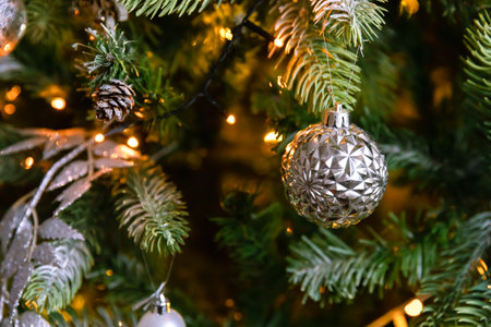 Classic Christmas decorated New year tree. Christmas tree with wite and silver decorations, ornaments toy and ball. Modern classical style interior design apartment. Christmas eve at homeの写真素材