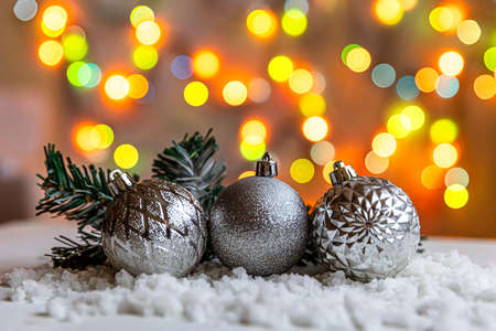 Abstract Advent Christmas Background. Winter decorations ornaments balls on background with snow and defocused garland lights. Merry Christmas time conceptの写真素材