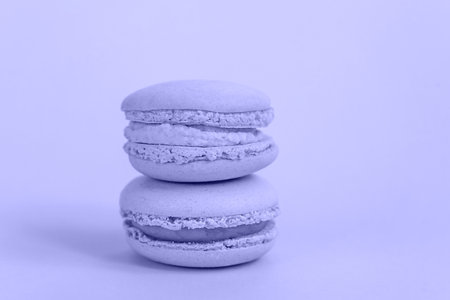 Sweet almond macaron or macaroon dessert cake colored in trendy color of year 2022 Very Peri background. Color of the year conceptの写真素材