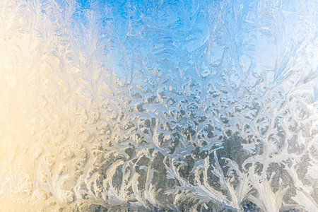 Frozen winter window with shiny ice frost pattern texture. Christmas wonder symbol, abstract background. Extreme north low temperature, natural Ice snow on frosty glass, cool winter weather outdoorの写真素材