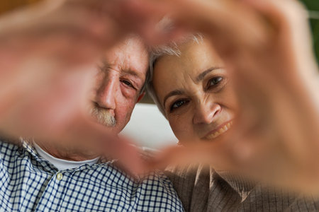 Love heart shape peace. Senior older couple making heart shape with their hands. Adult mature old husband wife showing heart sign. Happy pensioner family. I love you happy valentines dayの写真素材