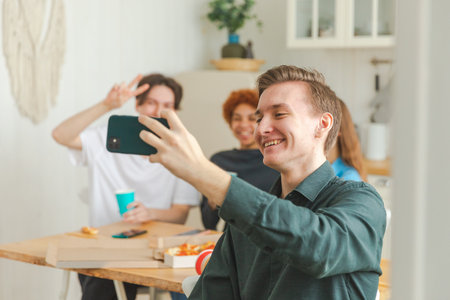 Cheers Funky mood. Happy group of friends make selfie. Man taking photo of friends at party. Group...