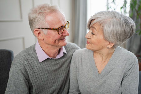 Senior adult mature couple hugging at home. Mid age old husband and wife embracing with tenderness...