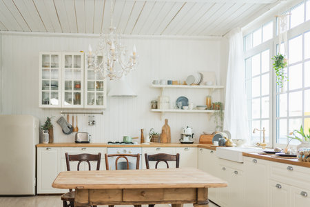 Empty white wooden kitchen interior with dining room. Scandinavian classic minimalistic bright kitchen with white and wooden details. Modern white kitchen clean contemporary style interior designの写真素材