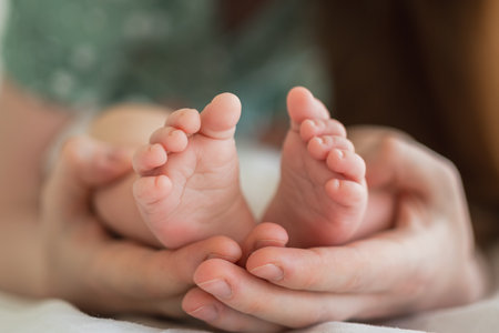 Happy family. Tiny newborn infant male or female baby feet on mother hands. Mother holding newborn child. Mom and her baby. Maternity tenderness parenthood new life concept. Handle with careの写真素材