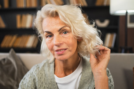 Portrait of confident stylish European middle aged senior woman. Older mature 60s lady smiling at home. Happy attractive senior female looking camera close up face headshot portrait. Happy peopleの写真素材
