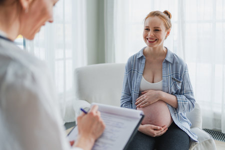 Female doctor examining pregnant woman in doctor office. Pregnant girl patient have consultation in hospital. Gynecologist doctor consulting patient about pregnancy. Visit to doctor medical checkupの写真素材