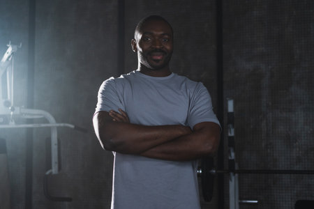 Fitness workout in gym. Portrait of African American man standing in gym with motivation health energy ready for training. Athletic coach personal trainer fitness club owner. Healthy lifestyleの写真素材