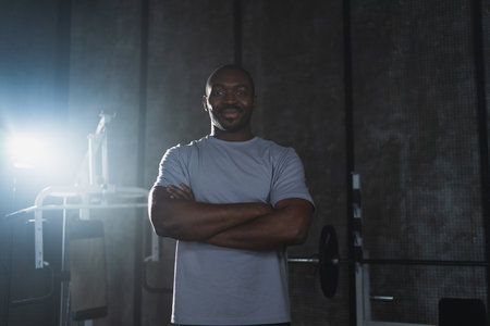Fitness workout in gym. Portrait of African American man standing in gym with motivation health energy ready for training. Athletic coach personal trainer fitness club owner. Healthy lifestyleの写真素材