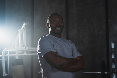 Fitness workout in gym. Portrait of African American man standing in gym with motivation health energy ready for training. Athletic coach personal trainer fitness club owner. Healthy lifestyleの写真素材