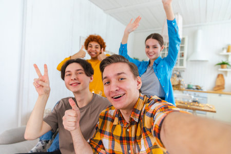 Cheers Funky mood. Happy friends make selfie. Man taking photo of friends at party. Group of multiracial people taking photo on phone. Young people enjoy their company smile have fun. Webcamera viewの写真素材