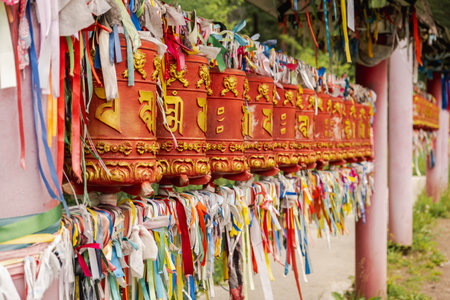 Rotating religious elements for touching turning spinning Buddhist prayer wheel at Buddhist monastery. Prayer wheels in Buddhist stupa temple. Buddhism religion conceptの写真素材