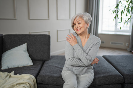 Portrait of confident stylish european middle aged senior woman. Older mature 60s lady smiling at home. Happy attractive senior female looking camera close up face headshot portrait. Happy peopleの写真素材