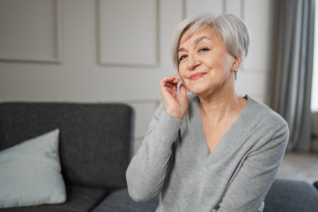 Portrait of confident stylish european middle aged senior woman. Older mature 60s lady smiling at home. Happy attractive senior female looking camera close up face headshot portrait. Happy peopleの写真素材