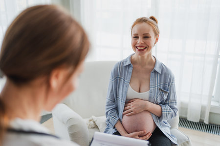Female doctor examining pregnant woman in doctor office. Pregnant girl patient have consultation in hospital. Gynecologist doctor consulting patient about pregnancy. Visit to doctor medical checkupの写真素材