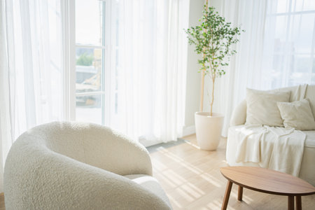 Stylish loft bedroom interior. Spacious design apartment with light walls large windows white couch sofa and armchair. Clean modern decoration with elegant furniture in minimalist Scandinavian styleの写真素材