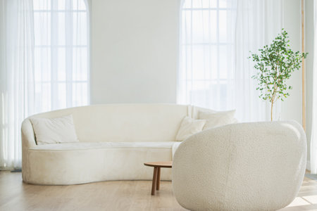 Stylish loft bedroom interior. Spacious design apartment with light walls large windows white couch sofa and armchair. Clean modern decoration with elegant furniture in minimalist Scandinavian styleの写真素材