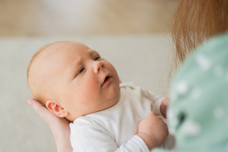 Happy family at home. Mother hands holding little toddler child daughter. Mom and baby girl relax...