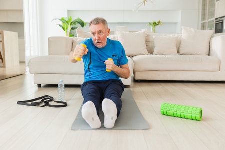 Fitness workout training. Senior man boxing punching picking up dumbbells. Old adult mature healthy man doing sports exercise at home. Grandfather have workout rehabilitation. Health care healthy lifestyleの写真素材