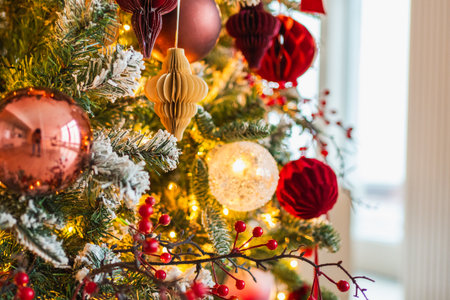 Merry Christmas Xmas happy holidays. Golden ornament decoration ball and defocused garland lights on classic decorated Christmas tree. Christmas tree with red white ornaments. Christmas eve at homeの写真素材