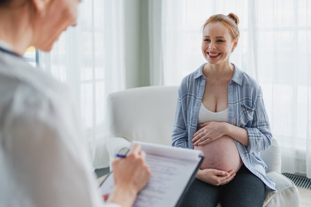 Female doctor examining pregnant woman in doctor office. Pregnant girl patient have consultation in hospital. Gynecologist doctor consulting patient about pregnancy. Visit to doctor medical checkupの写真素材