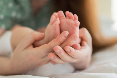 Happy family. Tiny newborn infant male or female baby feet on mother hands. Mother holding newborn child. Mom and her baby. Maternity tenderness parenthood new life concept. Handle with careの写真素材