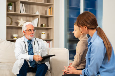Visit to pediatrician doctor. Mother with little preschooler son visit consult male pediatrician at hospital. Doctor examining boy. Family and doctor have consultation in doctor office clinic at homeの写真素材