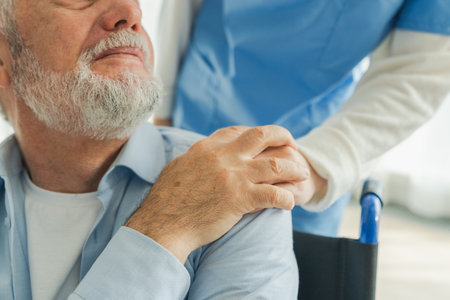 Help support retirement healthcare. Nurse helping old man in wheelchair. Patient and woman in nursing home for medical caregiver. Nurse taking care of paralyzed man in chair for people with disabilityの写真素材