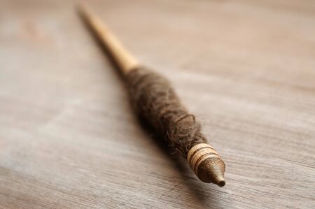 Traditional ancient spindle on dark wooden background