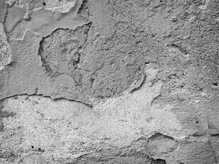 Textured white cement wall with ruined grungy plaster template background imageの写真素材
